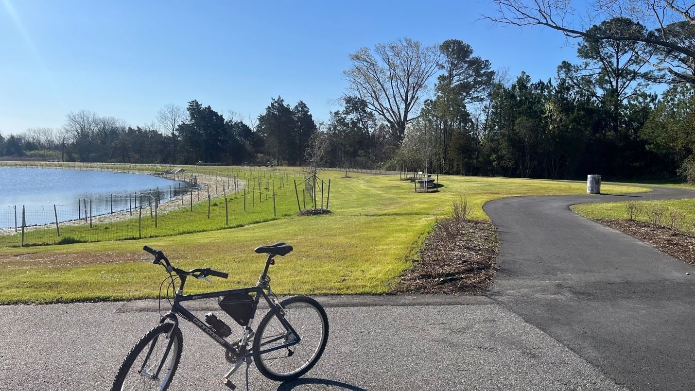 A bike is part on the WaterWalk trail near Coliseum Lake.