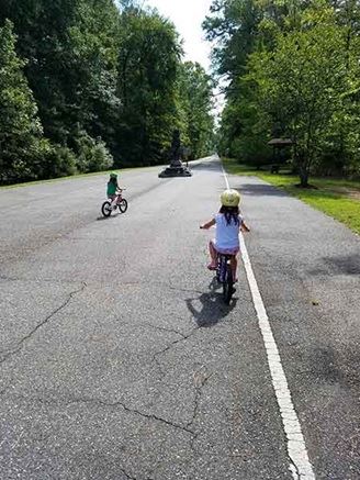 kids riding bikes on the Dismal Swamp Trail